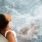lifestyle image of a woman in a pool relaxing