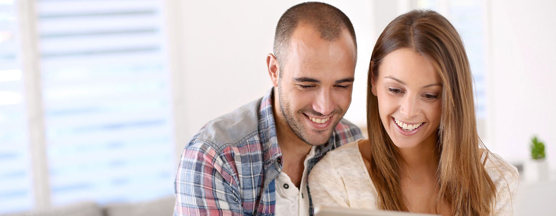 lifestyle image of a couple looking at a smart tablet together